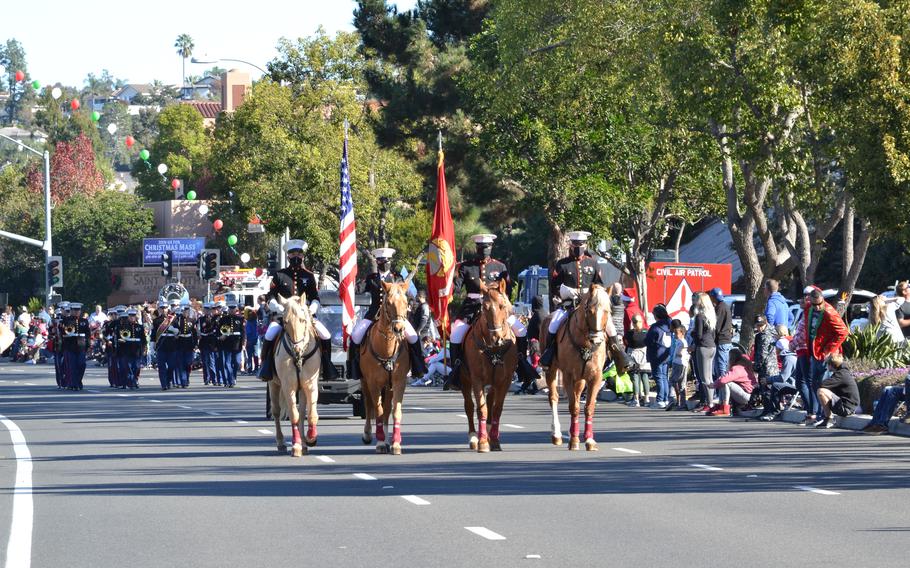 Marines from the Marine Corps Mounted Color Guard lead the Laguna Niguel Holiday Parade in Laguna Niguel, Calif., Dec. 11, 2021.  The Mounted Color Guard will participate in the Rose Parade on New Year’s Day and will be led by U.S. Marine Sgt. Amy Polachek.