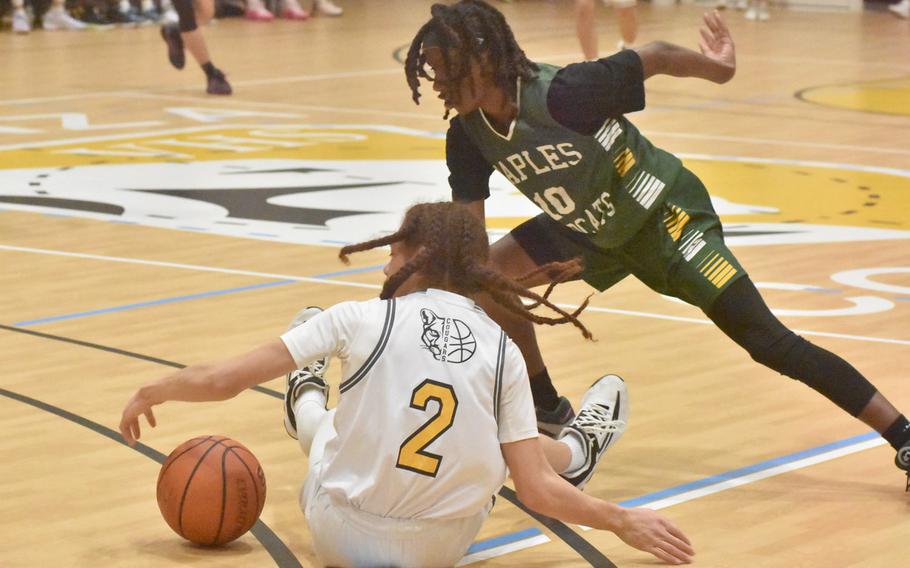 Vicenza’s Jace Herron and Naples’ Jeramiah Robinson try to grab a loose ball Friday, Feb. 2, 2024, in the the Cougars’ 65-49 victory over the Wildcats in Vicenza, Italy.