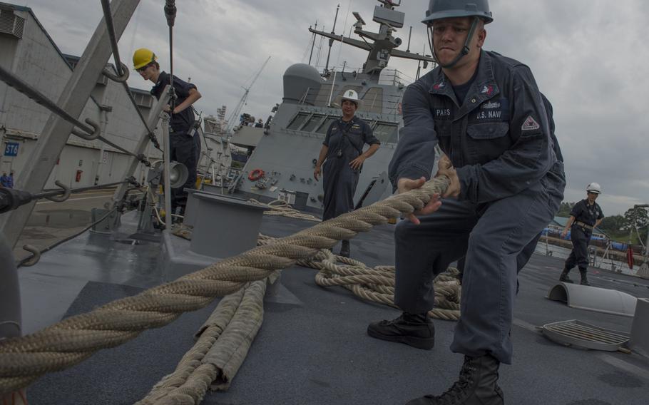 Culinary Specialist 1st Class Robert Parks from Fostoria, Ohio, heaves a mooring line aboard the littoral combat ship USS Fort Worth during a sea and anchor detail Feb. 19, 2015, in Singapore. The Navy has identified 24 ships on the chopping block in its budget proposal for 2023 released Monday, March 28, 2022. Nine are Freedom-class littoral combat ships.