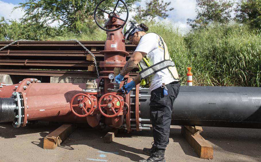 A Navy contractor collects a water sample from the Red Hill well shaft in Honolulu, Hawaii, in support of Joint Base Pearl Harbor-Hickam’s water restoration efforts, Feb. 7, 2022.
