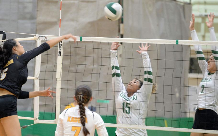Kadena's Haide Alvarez spikes between Kubasaki's Victoria Paul and Runa Holladay during Tuesday's Okinawa volleyball match. The Dragons won in four sets.