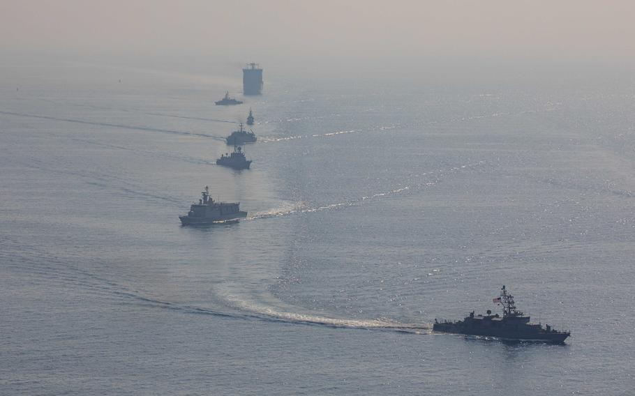 Ships from the navies of the U.S., Bahrain, Saudi Arabia and the United Kingdom sail in formation in the Persian Gulf on Oct. 26, 2022.