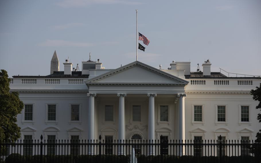 The U.S. flag on Saturday flies at half-staff over the White House after the deadly attack at Hamid Karzai International Airport. 