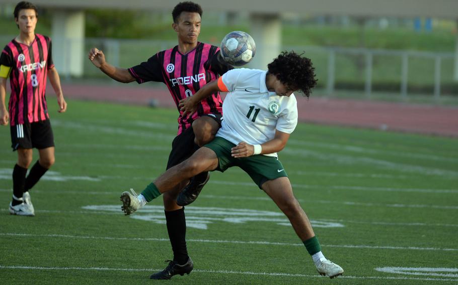 Kadena's Elijah Whipp and Kubasaki's Jaden Oshana try to play the ball during Wednesday's DODEA-Okinawa boys soccer match. The Panthers won 8-0.