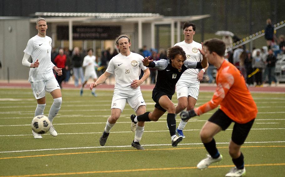 Stuttgart forward Ryan Stevenson stumbles as Ramstein defender Jayden Andrews watches the ball bounce away during a match April 27, 2024, at Stuttgart High School in Böblingen, Gemany.