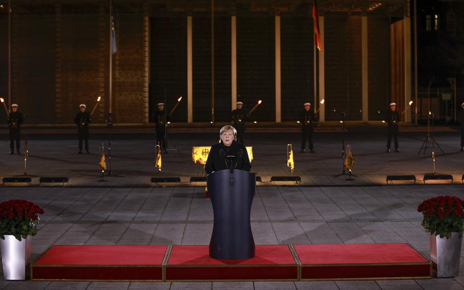 German Chancellor Angela Merkel makes a speech at the Defence Ministry during the Grand Tattoo (Grosser Zapfenstreich), a ceremonial send-off for her, in Berlin on Thursday, Dec. 2, 2021.