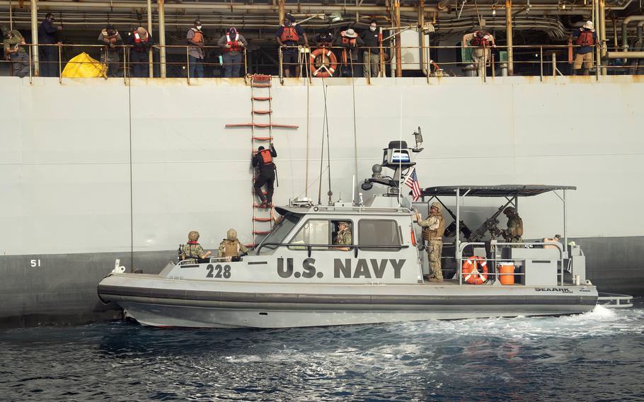 One of four Somali fishermen rescued by U.S. sailors in the Gulf of Aden, climbs down a ladder from USNS Patuxent to U.S. Navy Maritime Expeditionary Security Squadron Eleven Patrol Boat 228, based at Camp Lemonnier, Djibouti, June 17, 2021. The fishermen were stranded at sea after a mechanical failure and were without food or water for several days.