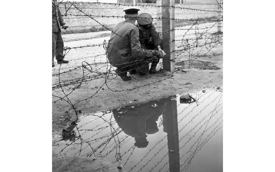 Barbed wire plays an important part in the East Zone Communists’ scheme of things, as demonstrated by those Vops who are laying a strand at the border in Berlin.