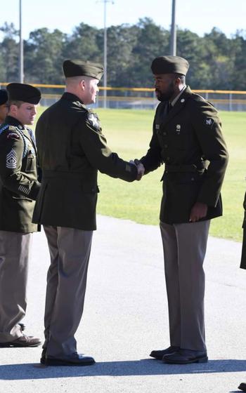 Two soldiers shaking hands.