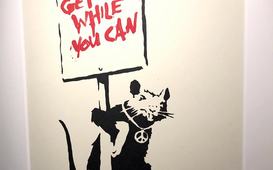 One room of the "Banksy: Genius or Vandal?" exhibit in Tokyo features the anonymous arist's work with images of rats.