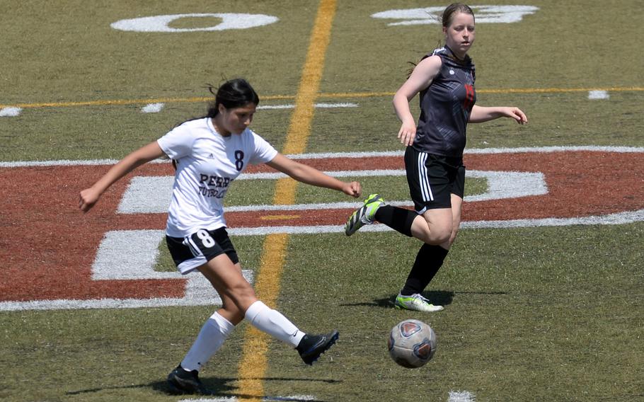 Matthew C. Perry's Leilani Zuniga boots the ball ahead of Nile C. Kinnick's MacKenzie Talbot during Saturday's DODEA-Japan girls soccer match. The Red Devils won 2-0.