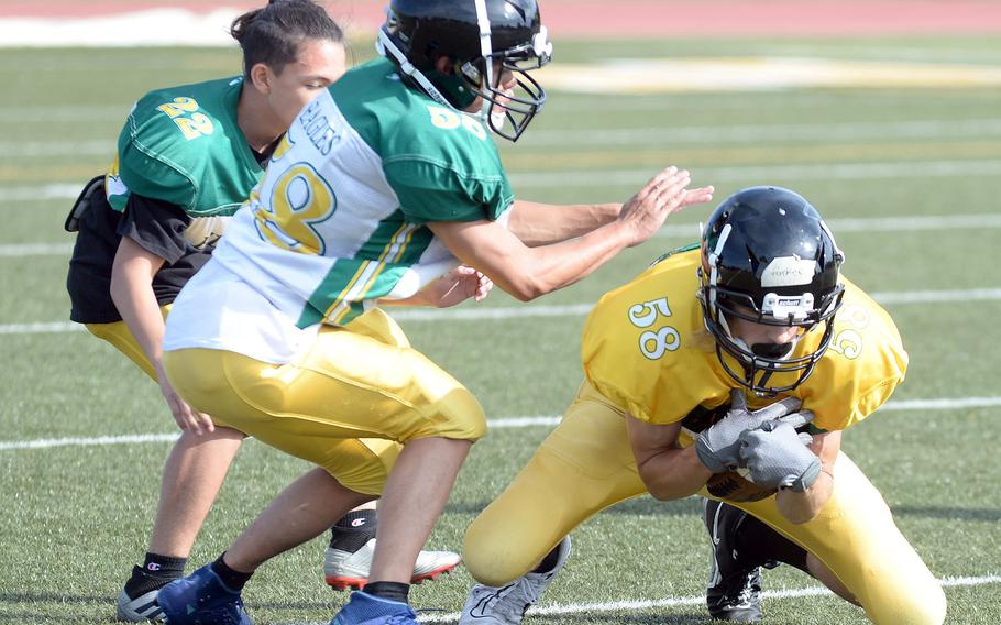 Edgren freshman Parker Kunz recovers a fumble.