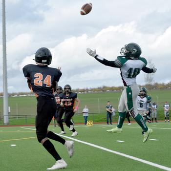 Spangdahlem’s Robert Leggett prepares to catch a ball that is floated over AFNORTH’s Nik Fulde during a DODEA-Europe Division III semifinal in Spangdahlem, Germany