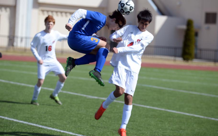 Yokota’s Brandon Christenson goes up to head the ball against E.J. King’s Alex Lachica during Friday’s Cobras’ 2-0 Perry Cup win.