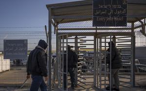 FILE - Palestinian workers enter Israel after crossing from Gaza on the Israeli side of Erez crossing between Israel and the Gaza Strip, on March 27, 2022. Israel reopened a main crossing with the Gaza Strip on Thursday, Sept. 28, 2023 allowing thousands of Palestinian laborers to enter the country for the first time since sealing it last week. (AP Photo/Oded Balilty, File)