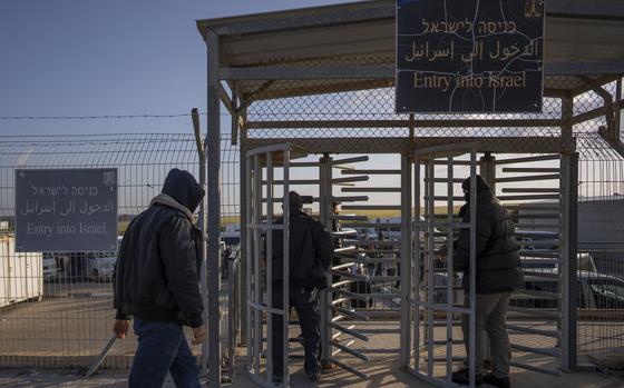 FILE - Palestinian workers enter Israel after crossing from Gaza on the Israeli side of Erez crossing between Israel and the Gaza Strip, on March 27, 2022. Israel reopened a main crossing with the Gaza Strip on Thursday, Sept. 28, 2023 allowing thousands of Palestinian laborers to enter the country for the first time since sealing it last week. (AP Photo/Oded Balilty, File)
