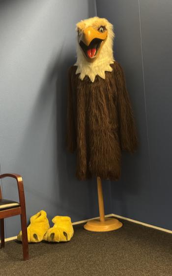 AFN Eagle mascot costume propped up in the corner of a room