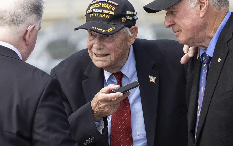 Veteran Les Jones receives a Greatest Generation coin from U.S. Miny Chief Counsel John Schorn at the 20th anniversary celebration of the National World War II Memorial in Washington, D.C., May 25, 2024.