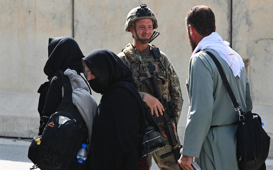 An Army paratrooper facilitates the evacuation of U.S. citizens, Special Immigrant Visa applicants and other at-risk Afghans in Kabul on Aug. 22, 2021. SIV applicants will have to file fewer forms, and their paperwork will now be handled by one government agency instead of two, the State Department announced July 18, 2022.