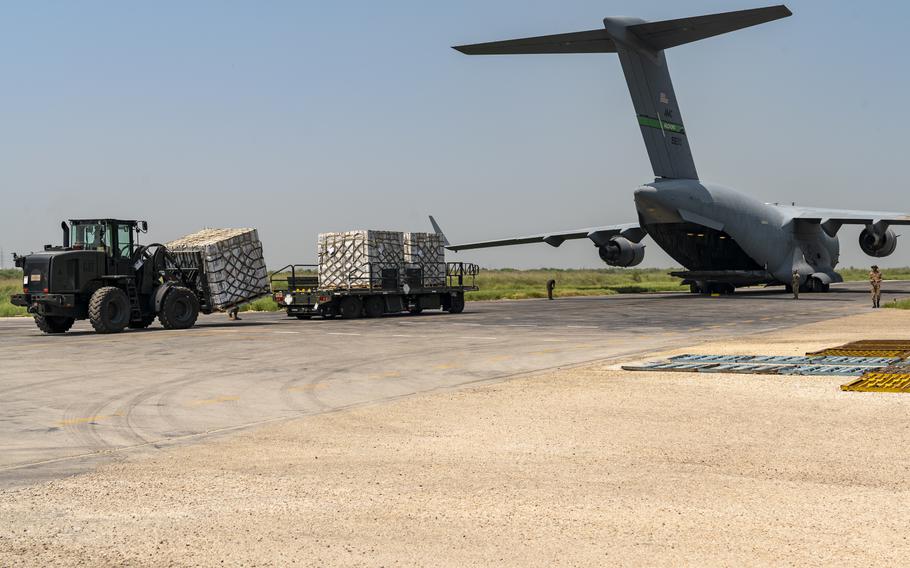 Service members unload supplies from an Air Force C-17 Globemaster III during a humanitarian aid mission at Sukkur Airport, Pakistan, Sept. 11, 2022. The aid mission to Pakistan was one of the last missions for members of the  816th Expeditionary Airlift Squadron, which deactivated Sept. 30.