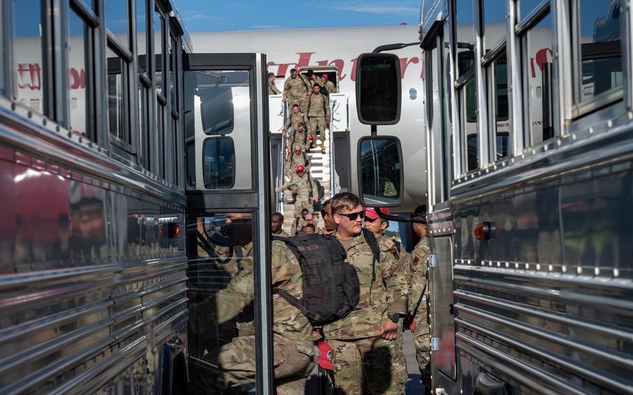 U.S. Air Force airmen assigned to the 823rd Rapid Engineer Deployable Heavy Operational Repair Squadron Engineer load onto a bus to reunite with their families at Hurlburt Field, Fla., Sunday, April 14, 2024. 