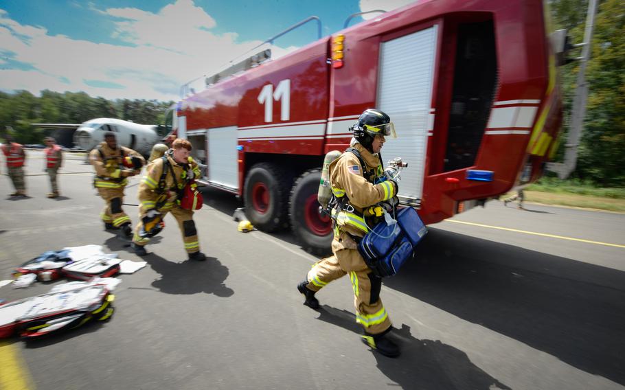 Firefighters assigned to the 86th Civil Engineer Group respond to a real medical emergency call involving an unconscious base employee at Ramstein Air Base, Germany, July 26, 2022. The first responders answered the emergency call in the midst of an ongoing simulated aircraft crash exercise scenario.