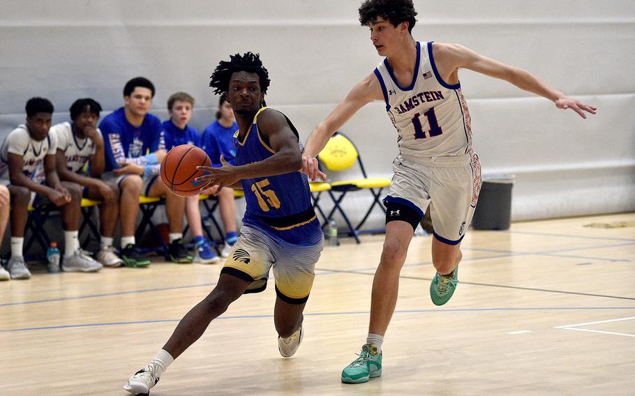 Wiesbaden junior Zion Thompson drives against Ramstein junior Michael Gonzales during pool-play action of the DODEA European basketball championships on Feb.14, 2024, at the Wiesbaden Sports and Fitness Center on Clay Kaserne in Wiesbaden, Germany.