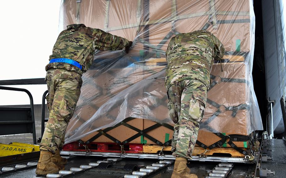 Airmen from the 730th Air Mobility Squadron push a pallet filled with perishable and frozen food items onto a C-130J Super Hercules at Yokota Air Base, Japan, June 3, 2023. The pallets were delivered to Andersen Air Force Base, Guam, to aid recovery efforts following Typhoon Mawar.