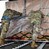 Airmen from the 730th Air Mobility Squadron push a pallet filled with perishable and frozen food items onto a C-130J Super Hercules at Yokota Air Base, Japan, June 3, 2023. The pallets were delivered to Andersen Air Force Base, Guam, to aid recovery efforts following Typhoon Mawar.