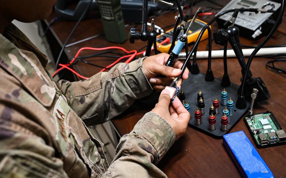 An airman assigned to Task Force 99 solders components at Al Udeid Air Base, Qatar, October 28, 2022. One of the main objectives of Task Force 99 is to accelerate the testing of critical technological capabilities.
