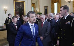 Defense Secretary Pete Hegseth departs a trophy presentation.