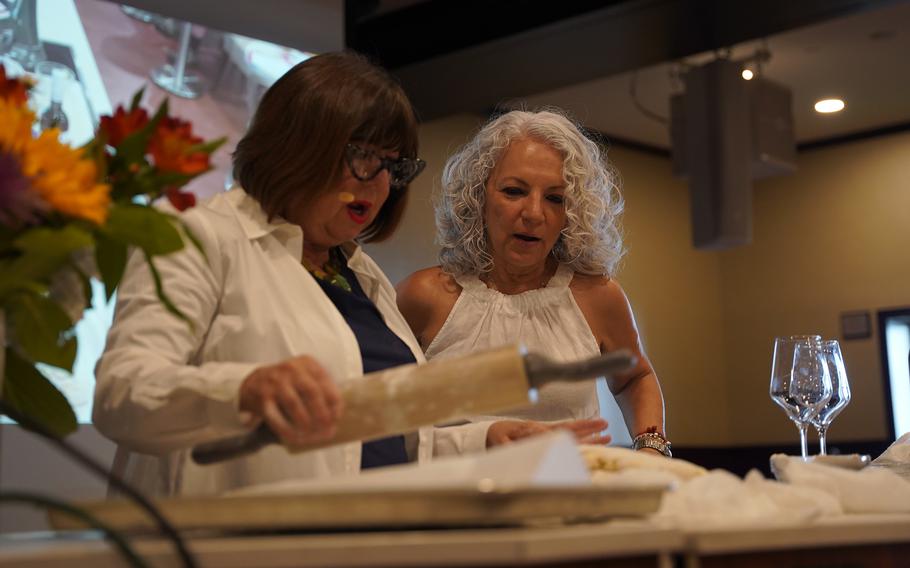 American Queen Voyages culinary ambassador Regina Charboneau shows passenger Lydia Gregory how to make the perfect biscuit during a “Biscuits and Bourbon” cooking demo.