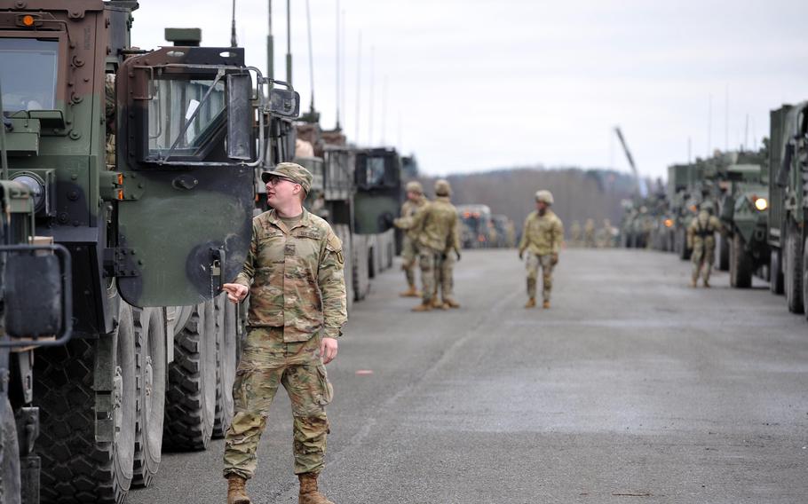 Soldiers of the 2nd Calvary prepare their vehicles for a deployment to Romania Feb. 9, 2022, at Vilseck Army Airfield, Germany. About 1,000 soldiers are being sent to reassure allies worried about Russia. 