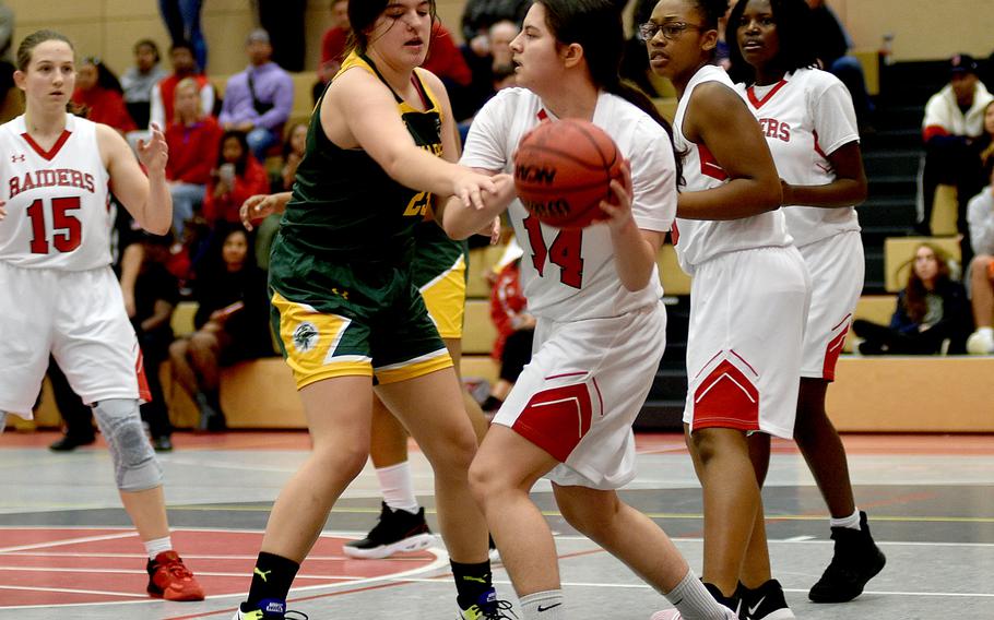 Kaiserslautern's Rihanna Martin looks to pass during Friday evening's game at Kaiserslautern High School in Kaiserslautern, Germany. Defending, center left, is SHAPE's Bella Smith, while Martin's teammates, from left, Elizabeth Marriott, Cambrielle Sanders and Gabrielle Myrica follow the action.