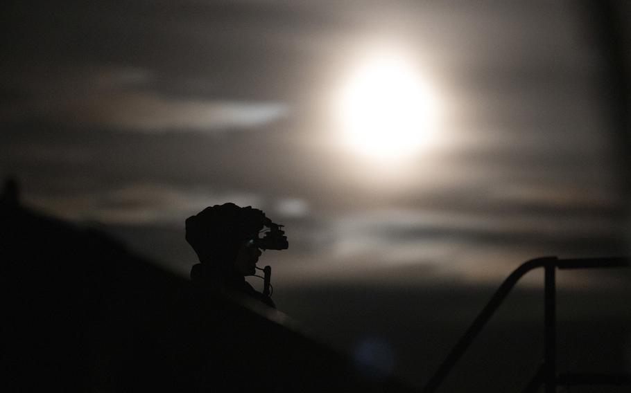 A soldier with 3rd Battalion, 1st Special Forces Group trains near the Columbia River in Oregon, May 26, 2021. A judge in Washington state sided with public opposition to the Navy using public parks along the river for SEAL training, but Army Green Berets have trained on the other side of the river in Oregon for decades with little public notice.