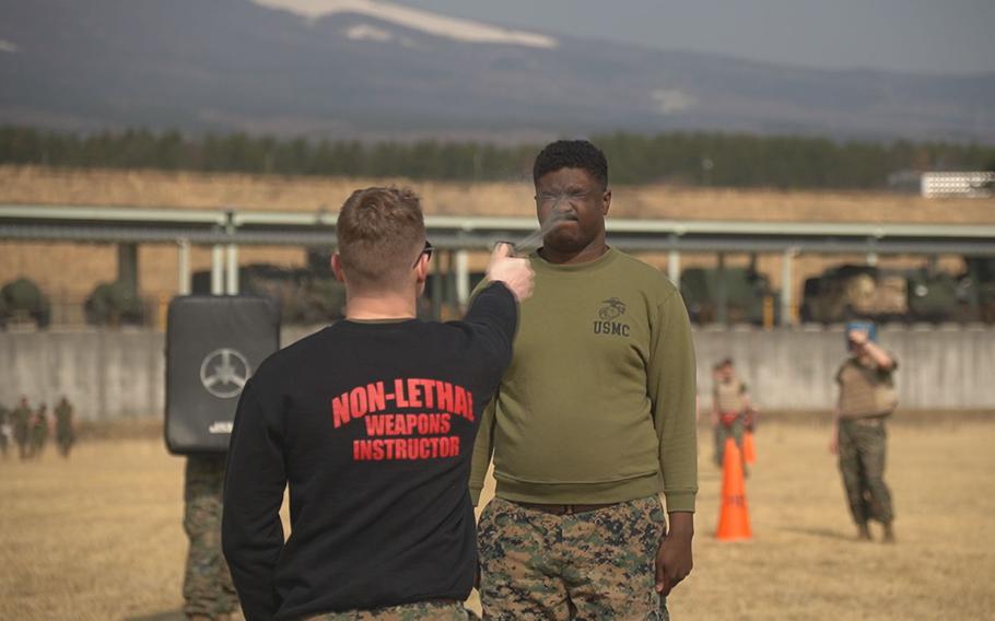A Marine is sprayed with pepper spray during a training.