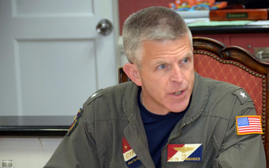 Rear Adm. Pat Hannifin, commander of Carrier Strike Group 5, speaks to reporters aboard the USS Ronald Reagan in the Philippine Sea, Monday, Nov. 6, 2023. 