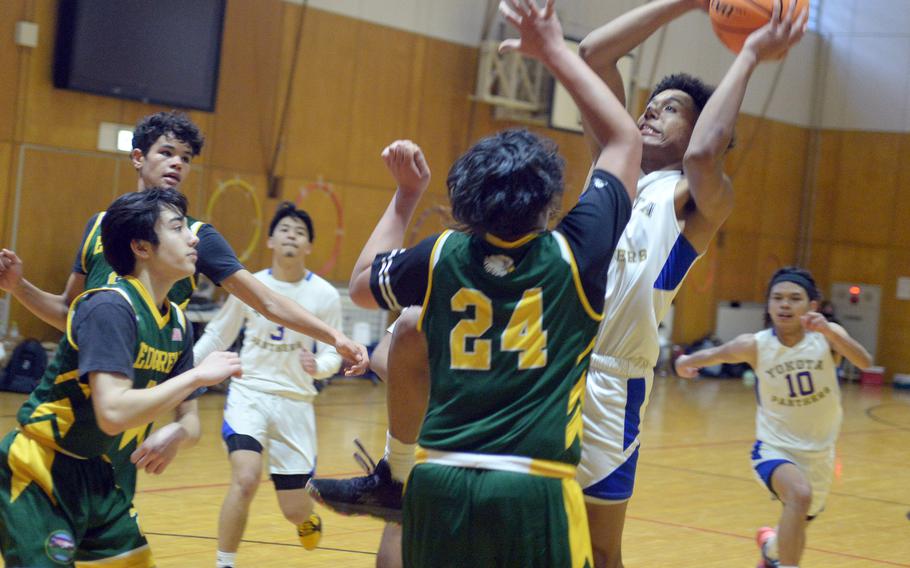 Yokota's Zemon Davis pulls up to shoot against Robert D. Edgren during Friday's 5th American School In Japan Kanto Classic boys knockout game. The Panthers won 53-24.