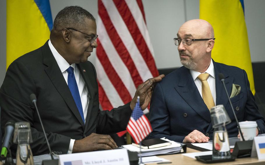 Defense Secretary Lloyd Austin greets his Ukrainian counterpart Oleksii Reznikov during the ninth Ukraine Defense Contact Group meeting at NATO headquarters in Brussels, Tuesday, Feb. 14, 2023.