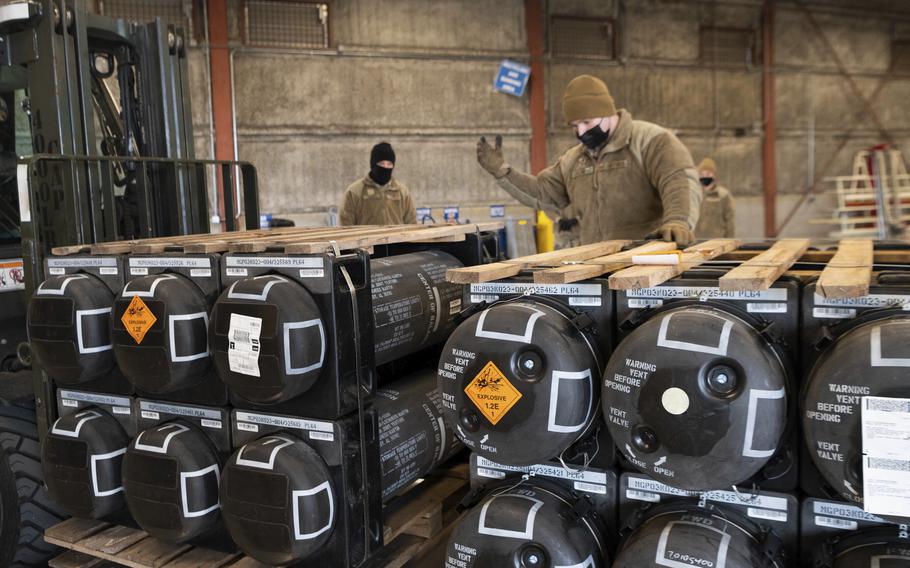 Airmen and civilians from the 436th Aerial Port Squadron palletize ammunition, weapons and other equipment bound for Ukraine during a foreign military sales mission at Dover Air Force Base, Del., on Jan. 21, 2022. 