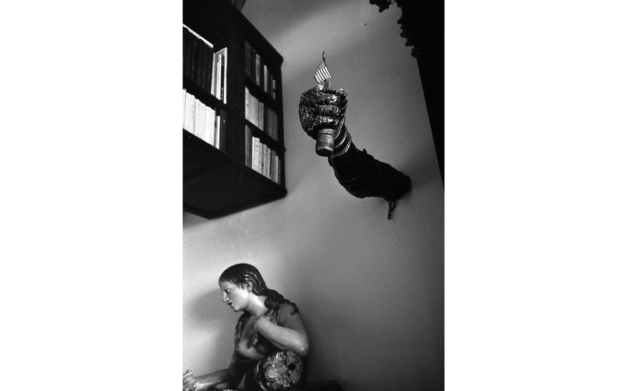 A wooden arm holding a miniature American flag extends from one wall of the library in Salvador Dali’s home, above a sculpture of a nude bust of a woman, her arm resting on a skull. The arm sculpture and the bust — the latter only known as “Maria Magdalene” — are two of several art pieces in the home of Salvador Dali in Port Lligat on the Spanish Costa Brava.