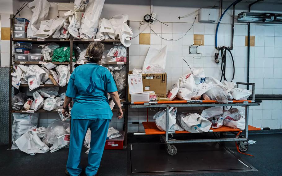 Tal Simmons scans shelves with bags of human remains at the National Institute of Forensic Medicine.