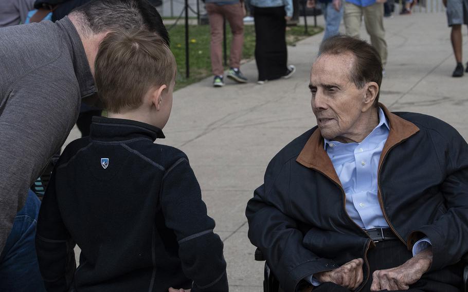Former Sen. Bob Dole talks with a young visitor to the National World War II Memorial in Washington, D.C., March 30, 2019.