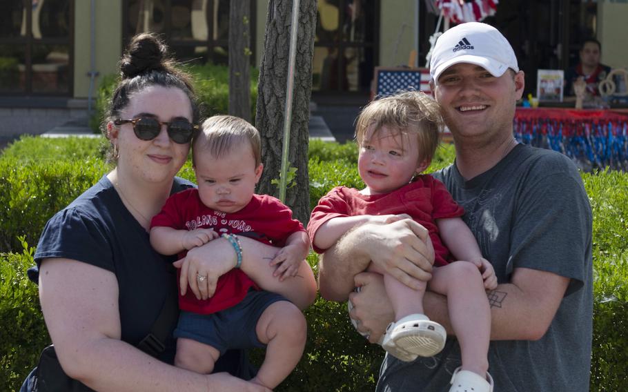 A family with two children poses for a photo.
