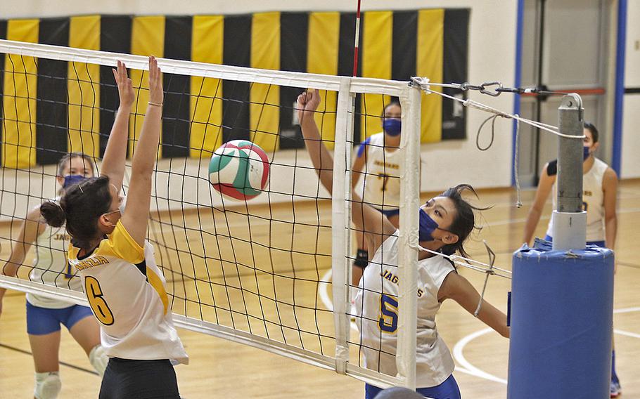 Sigonella's Angela Mykayla Abad tries to get the ball over Vicenza's Julia Ridgely during Saturday's game at Vicenza High School. Vicenza won in straight games 25-12, 25-12, 25-10. 