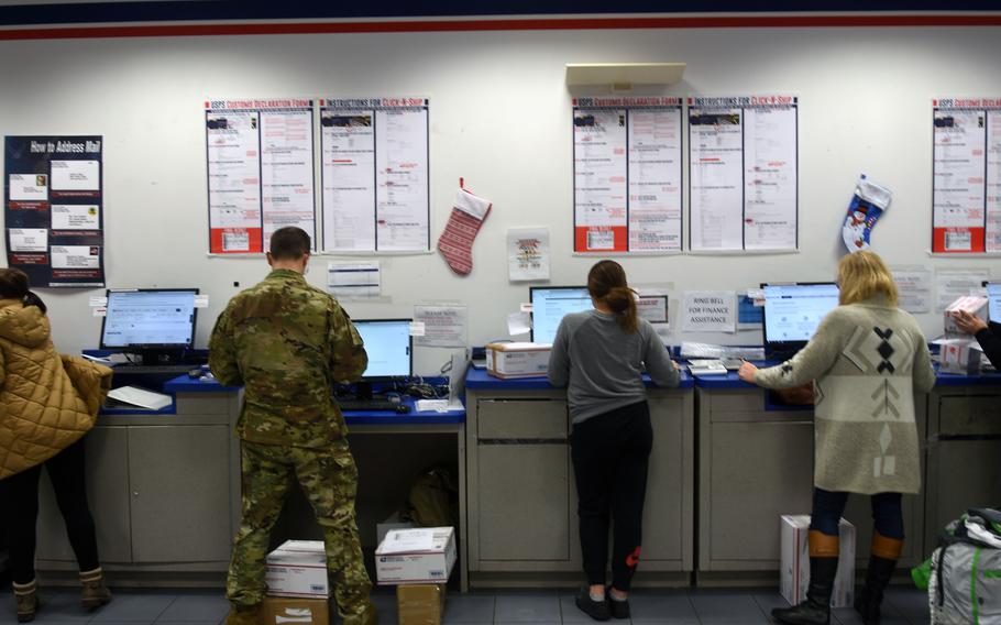 Customers fill out electronic customs forms at the Northside Post Office on Ramstein Air Base, Germany, on Monday, Dec. 5, 2022. Military officials say vague or outdated customs forms on parcels being mailed from the United States are reasons a higher than usual number of parcels are being returned to sender this holiday season.