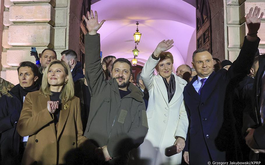 Poland’s President Andrzej Duda, right, and Ukraine’s President Volodymyr Zelenskyy wave to a crowd in Warsaw on Wednesday.