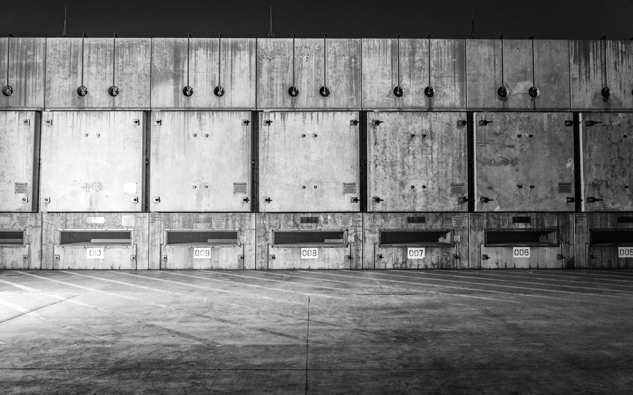 In the older section of the storage installation, a horizontal system contains 50 canisters of spent nuclear fuel. The canisters sit behind the large square panels. 