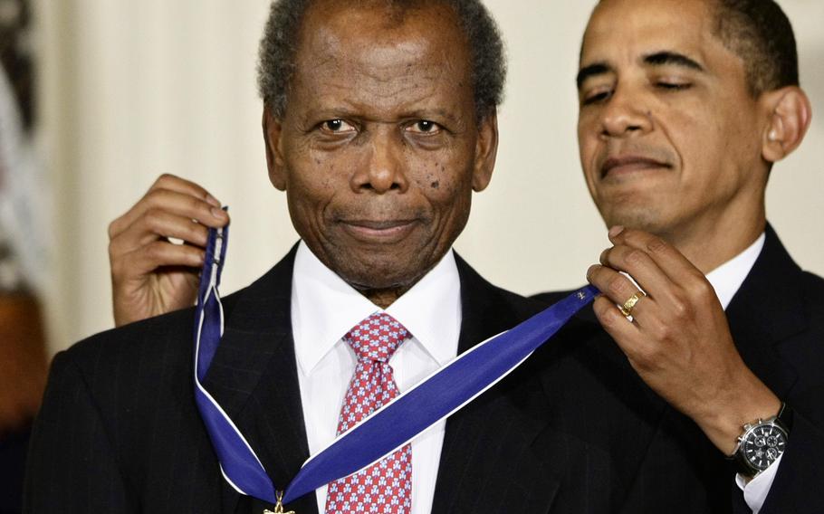 President Barack Obama presents the 2009 Presidential Medal of Freedom to Sidney Poitier during ceremonies in the East Room at the White House in Washington on Aug. 12, 2009.  Poitier died Thursday, Jan. 6, 2022 in the Bahamas. He was 94. 