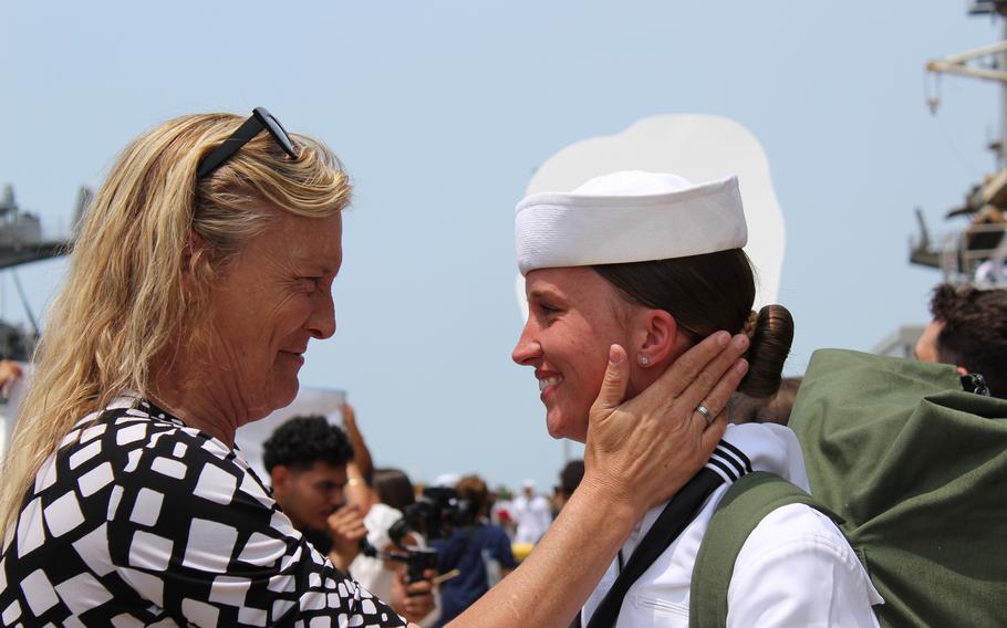 A sailor is greeted by a loved one